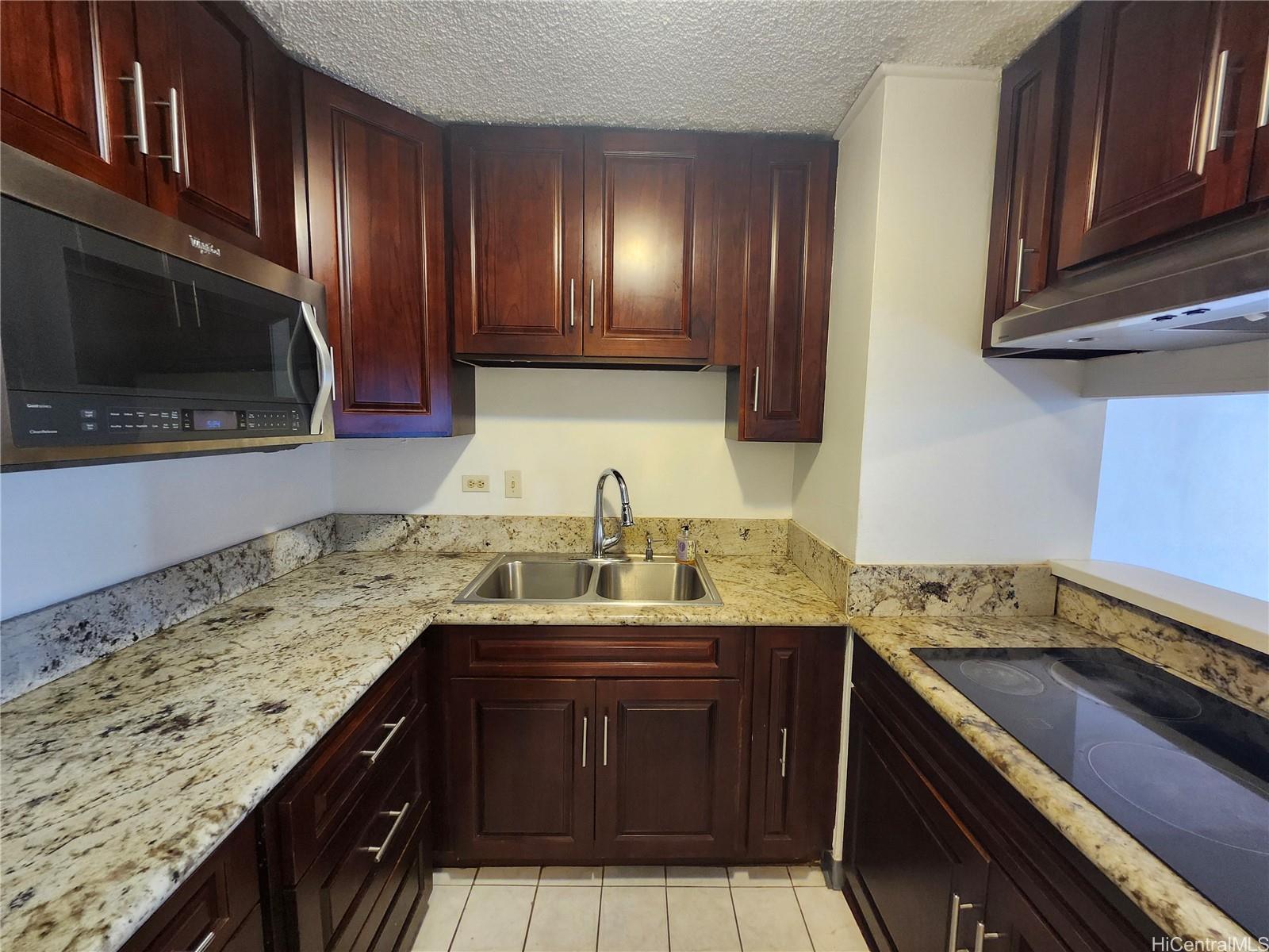 a kitchen with a sink and a stove