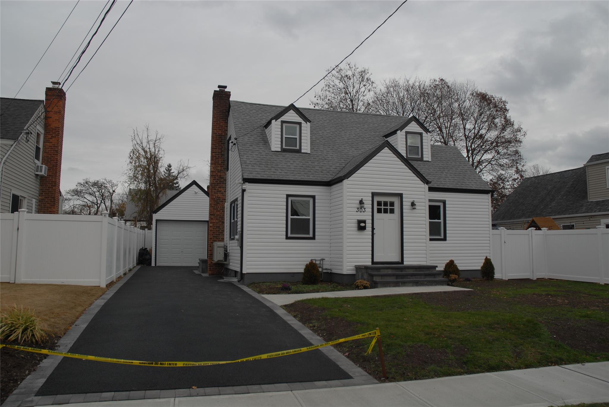 a view of a white house with a yard