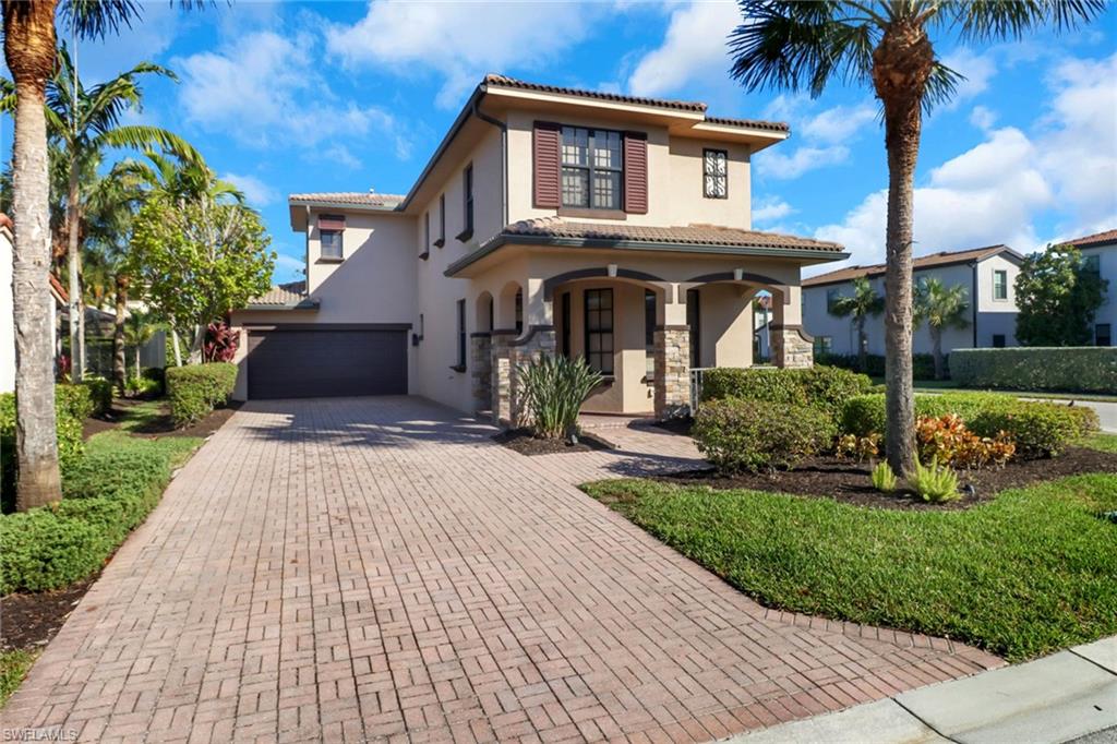 Mediterranean / spanish home with a porch and a garage