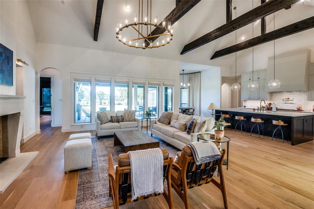 a living room with fireplace furniture and a wooden floor