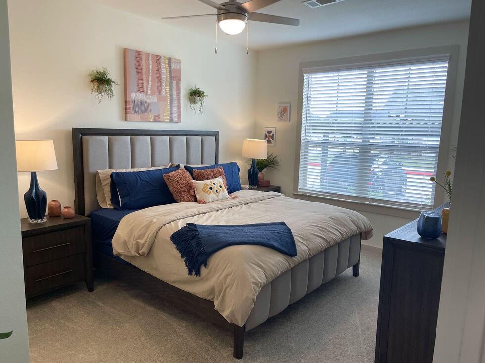 a bedroom with a bed and window