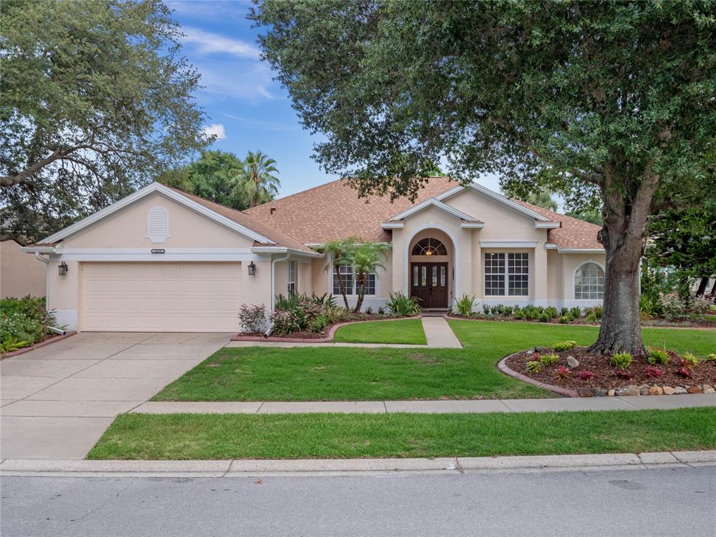 a front view of a house with a yard and garage