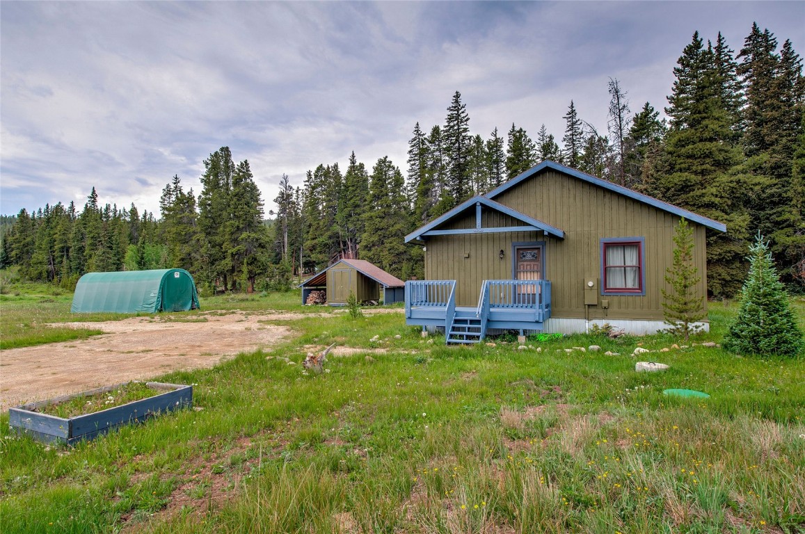 a view of a house with a yard and hanging chair