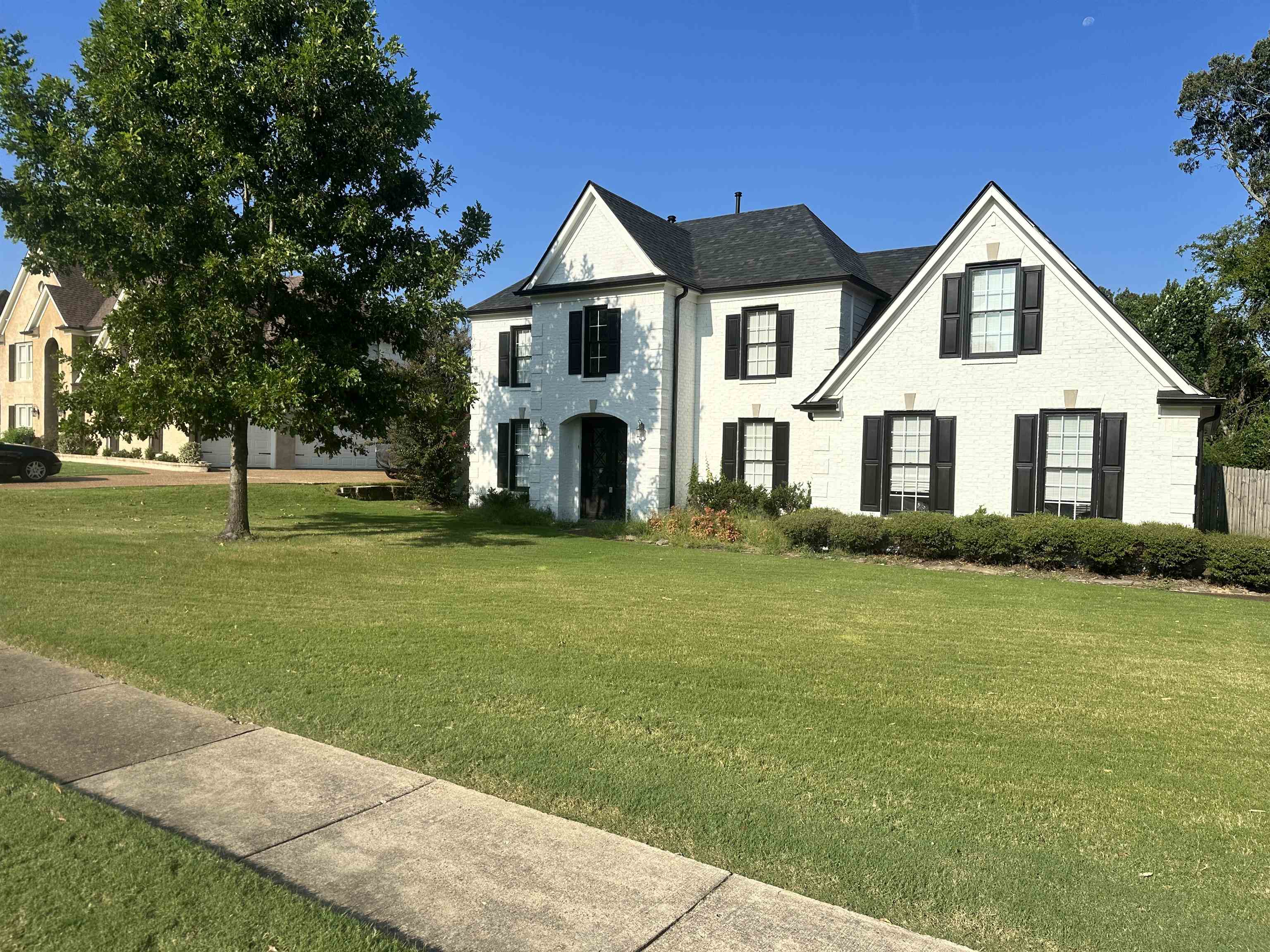 a front view of a house with a garden