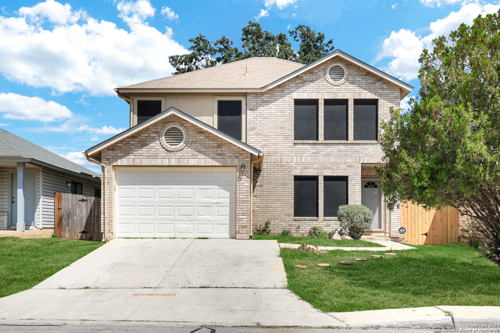 a front view of a house with a yard