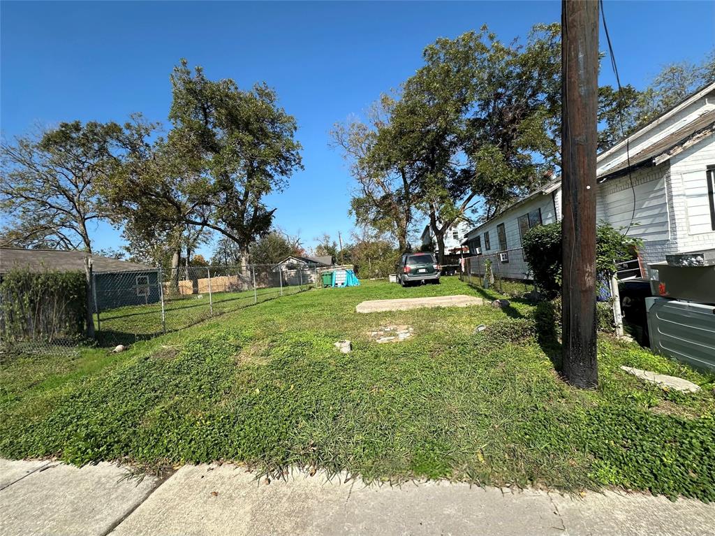 a view of a tree in front of a brick house