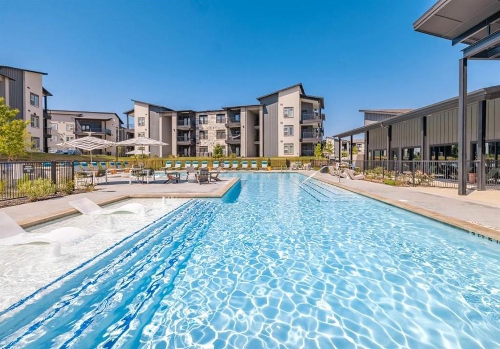 a swimming pool with outdoor seating and yard