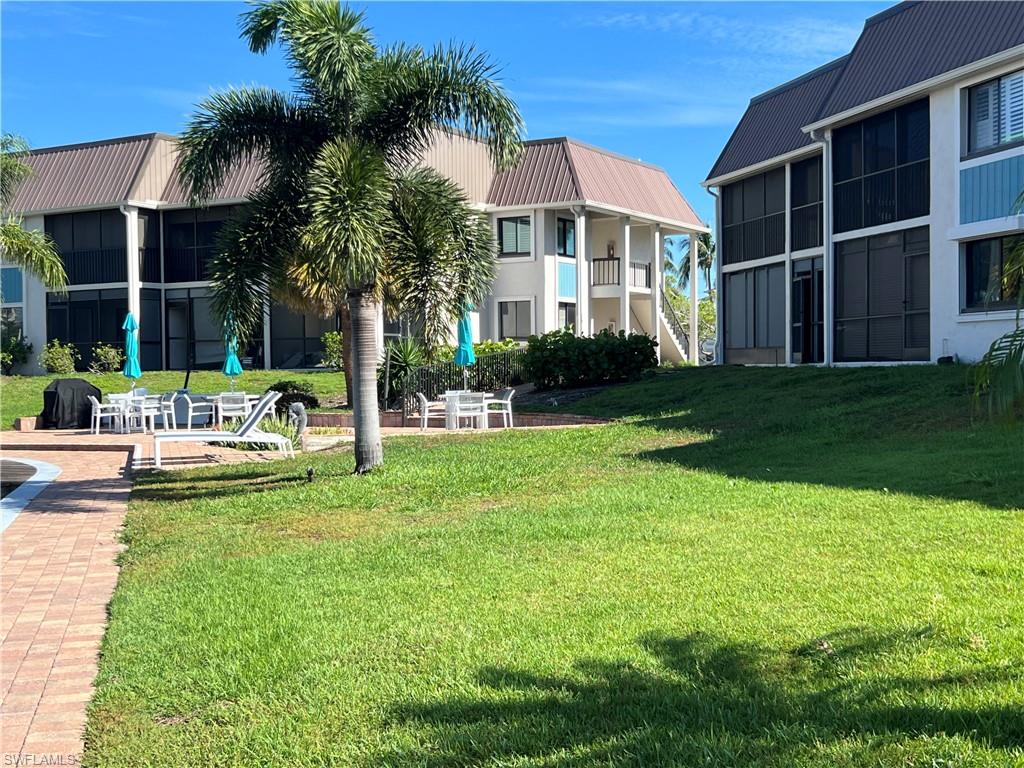 a view of a house with a yard and sitting area