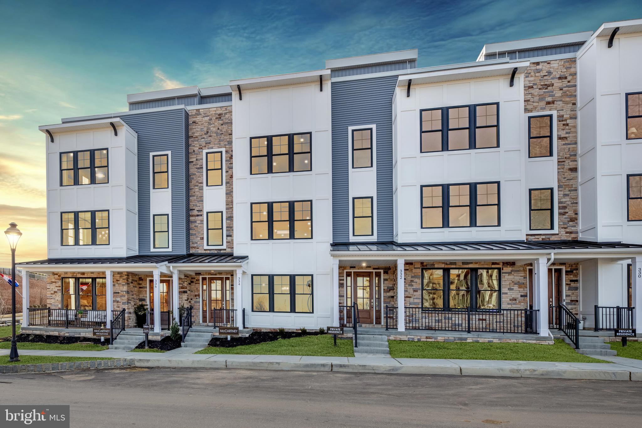 a front view of a residential apartment building with a yard