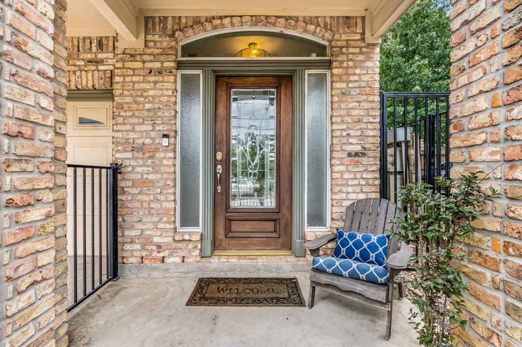 a view of a brick house with a large window and outdoor space