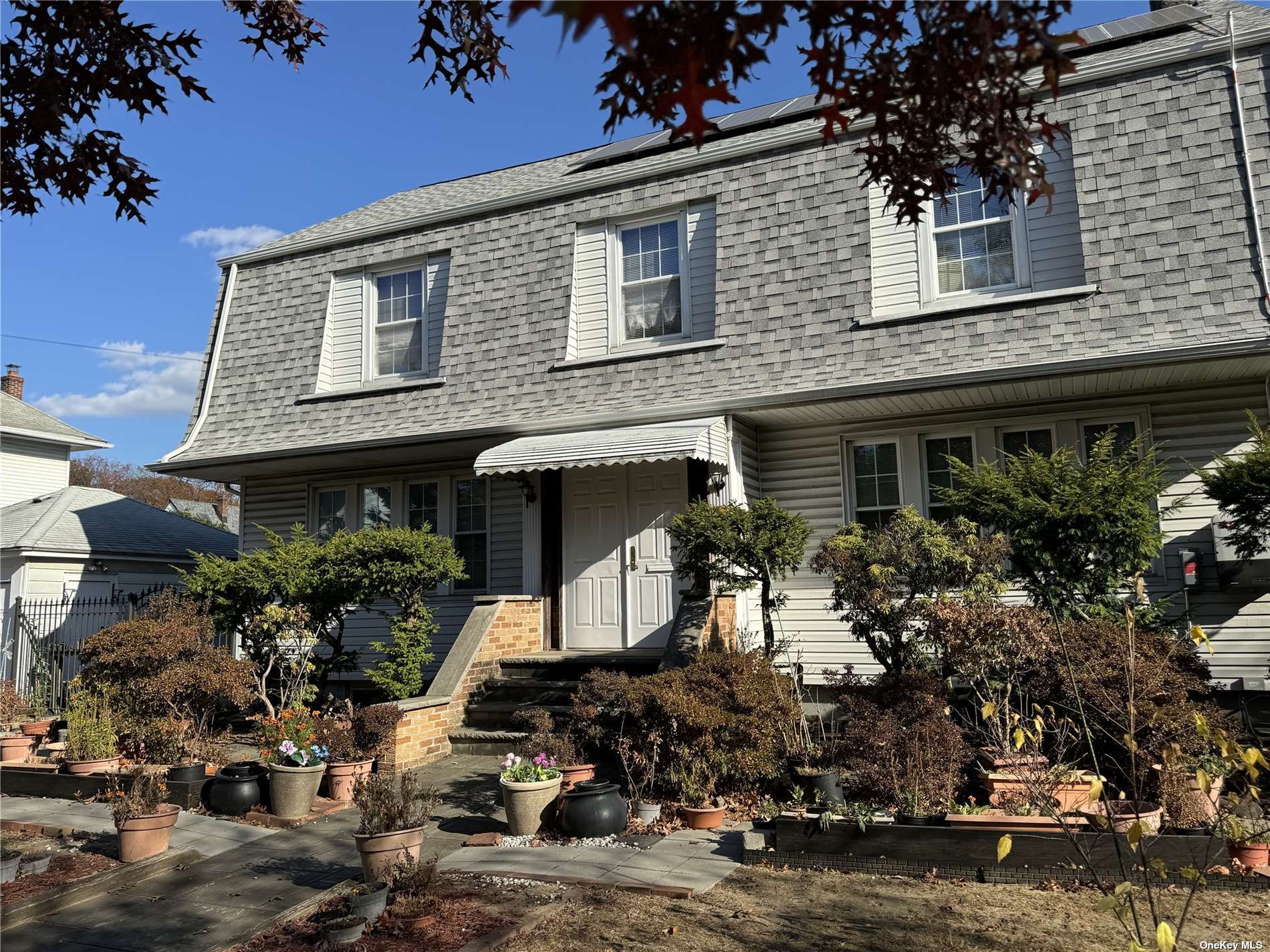 a front view of a house with garden