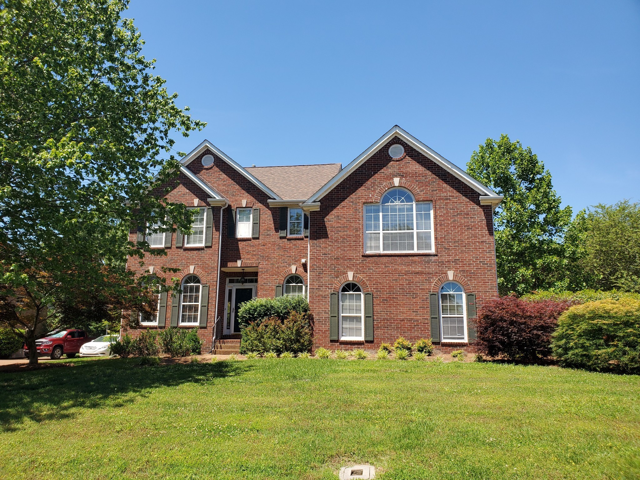 a front view of a house with a yard