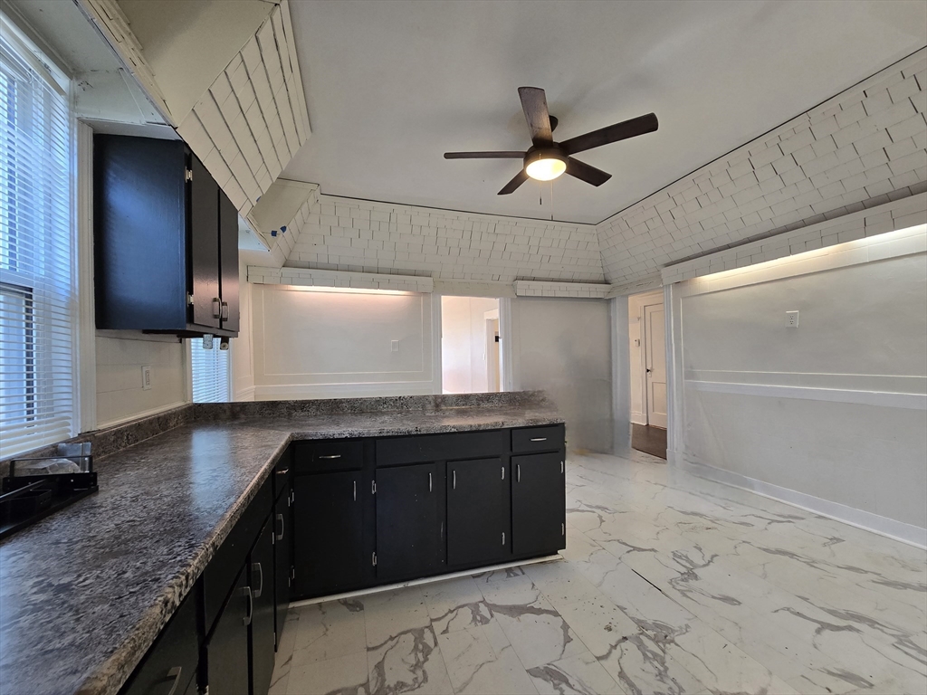 a kitchen with a sink a counter space cabinets and appliances