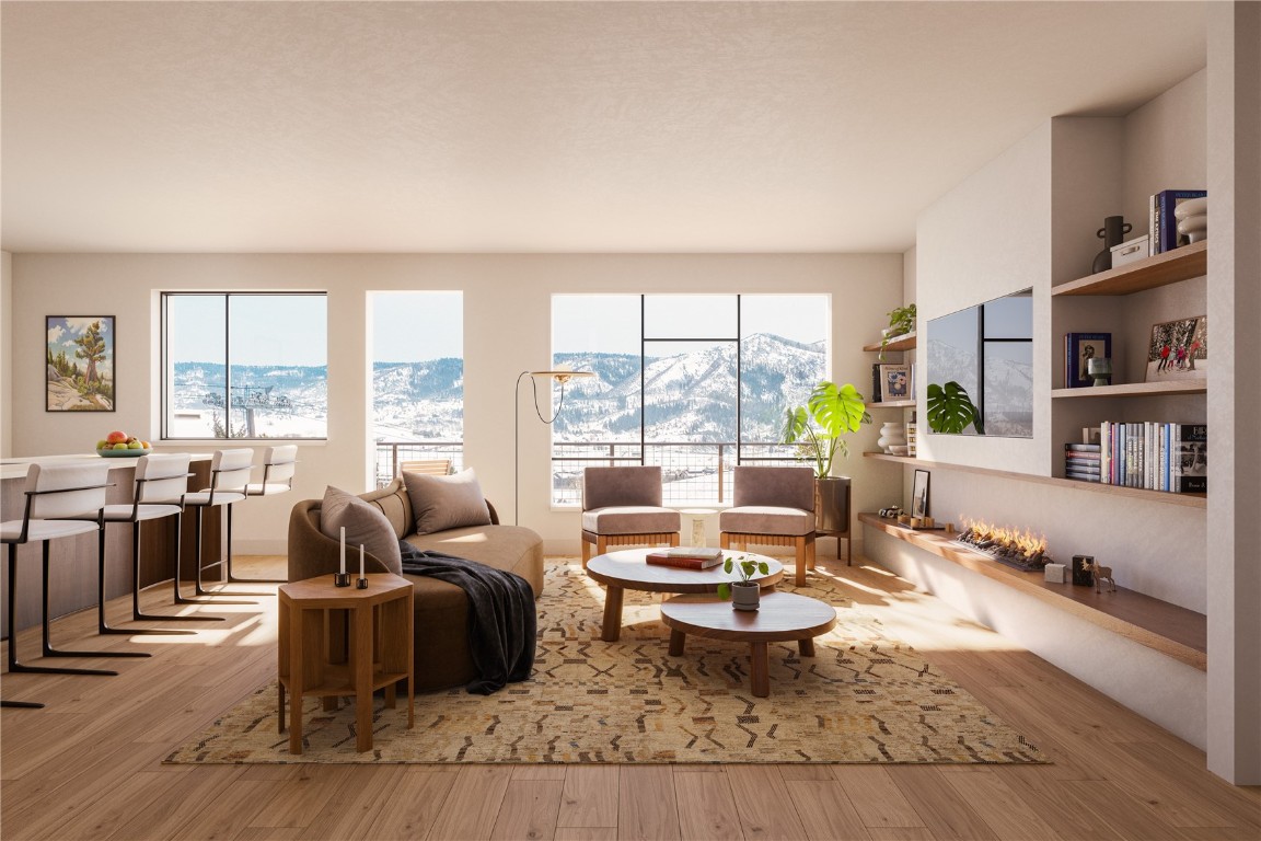 a living room with furniture large window and a table