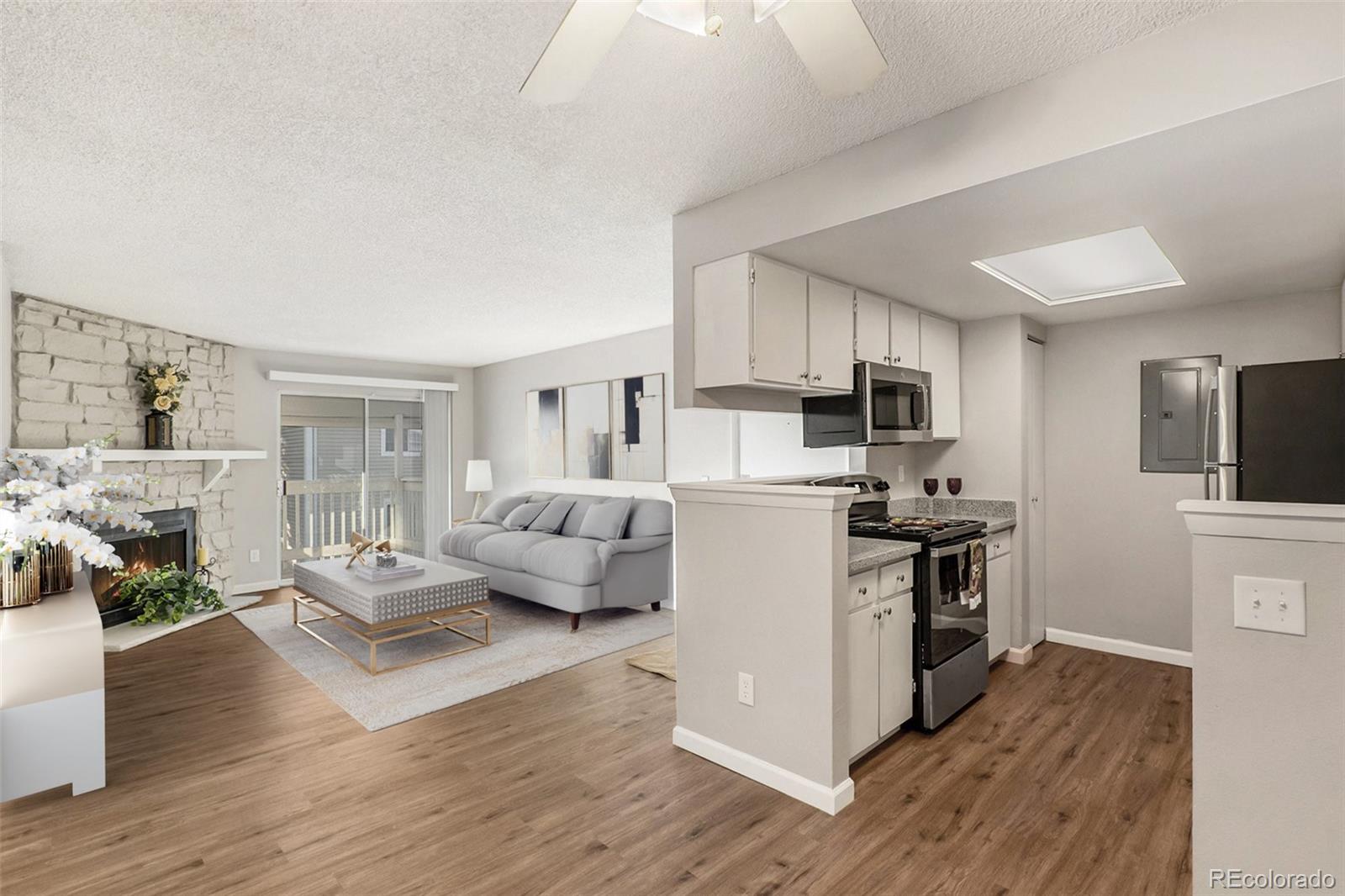 a living room with furniture flat screen tv and wooden floor