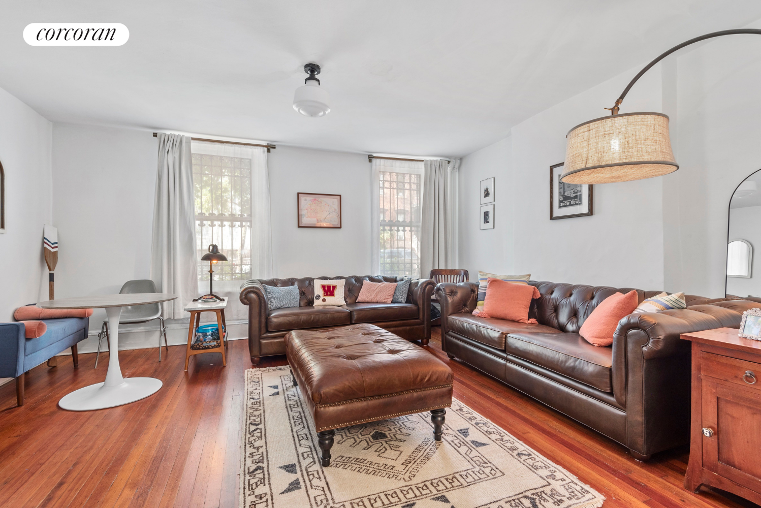 a living room with furniture and a wooden floor