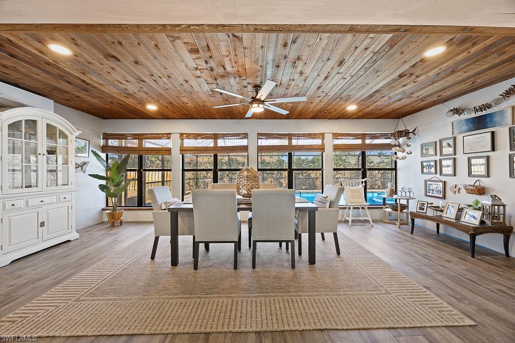 Dining area with hardwood / wood-style flooring, plenty of natural light, and wooden ceiling