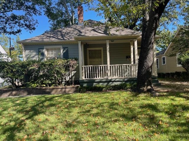 Bungalow-style house featuring a front lawn and covered porch