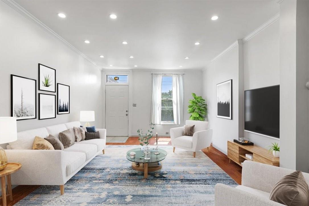 a living room with furniture and a flat screen tv