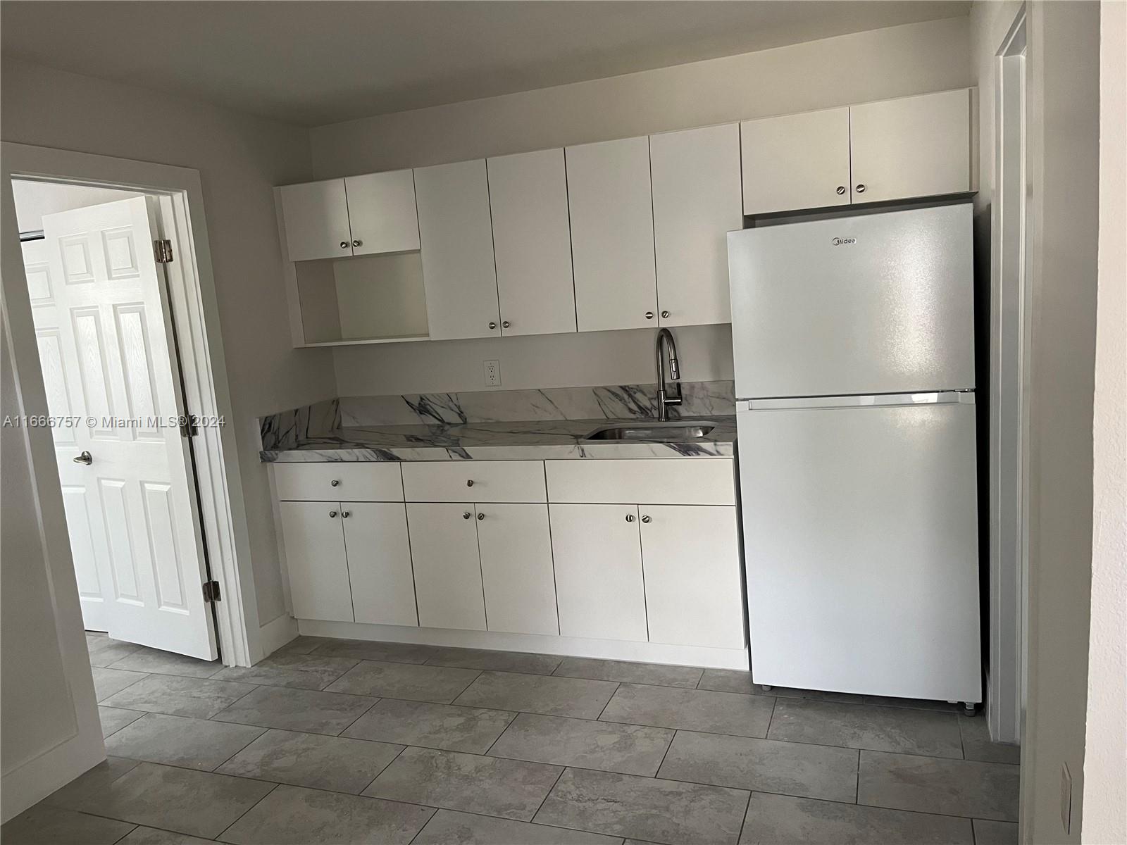 a white refrigerator freezer sitting in a kitchen