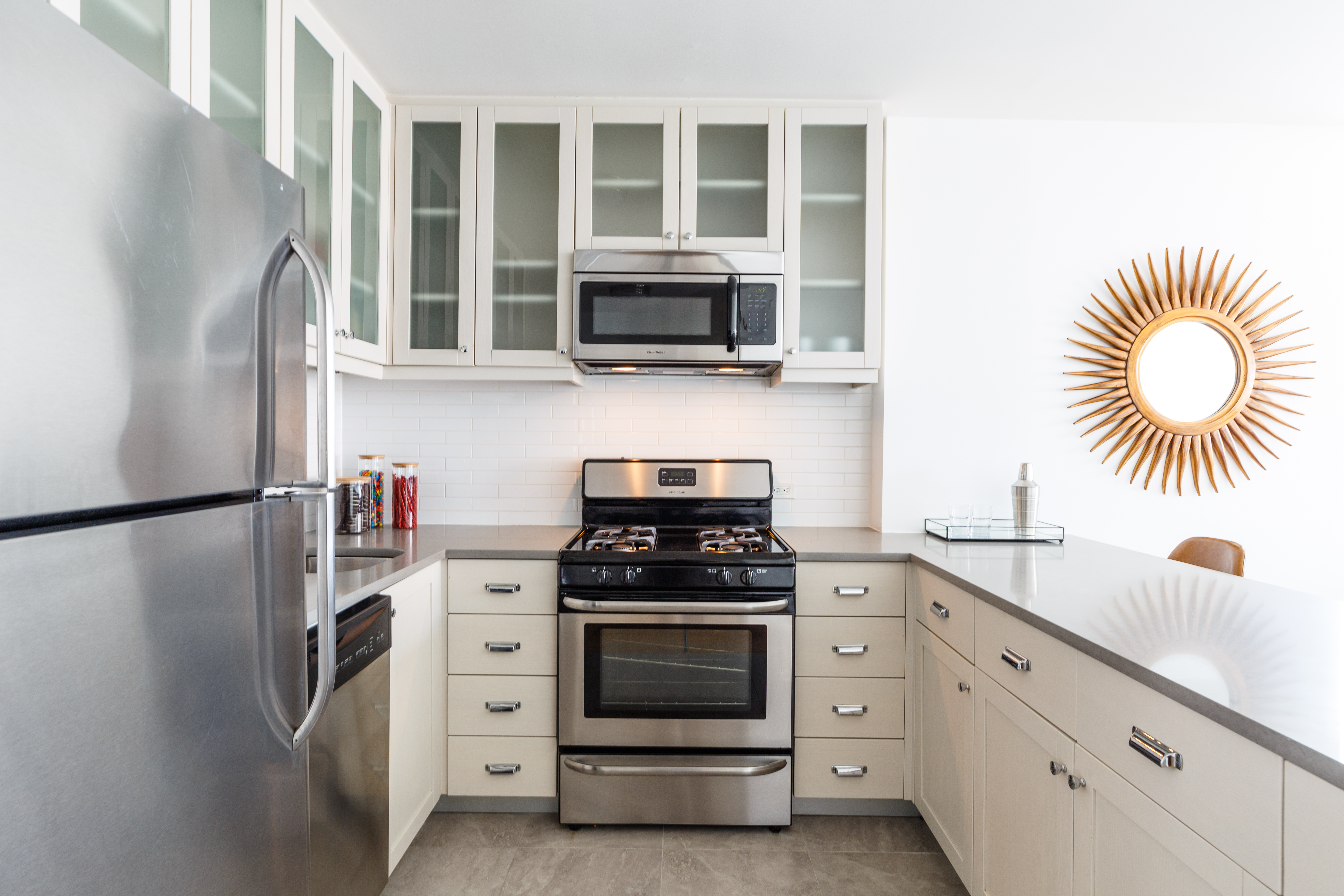 a kitchen with stainless steel appliances white cabinets and a stove