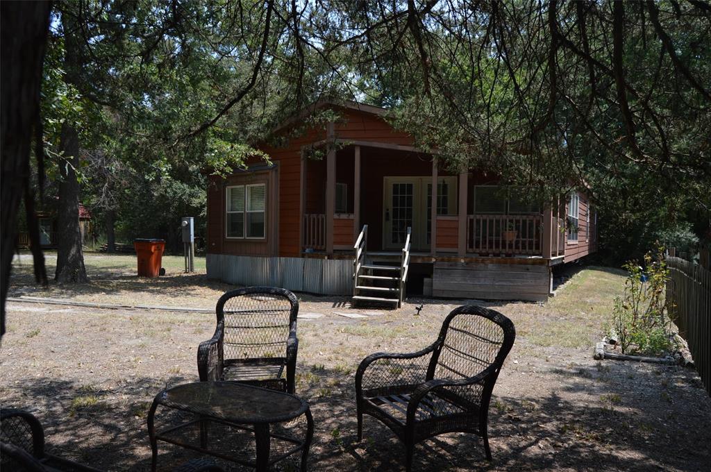 a view of backyard with seating space and trees