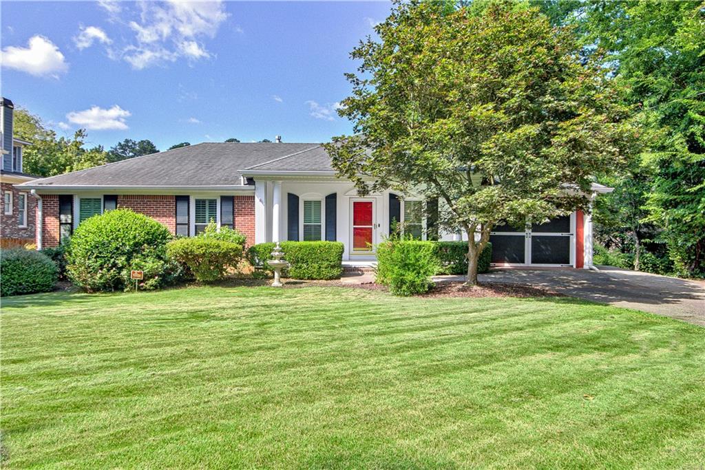 a front view of a house with a garden