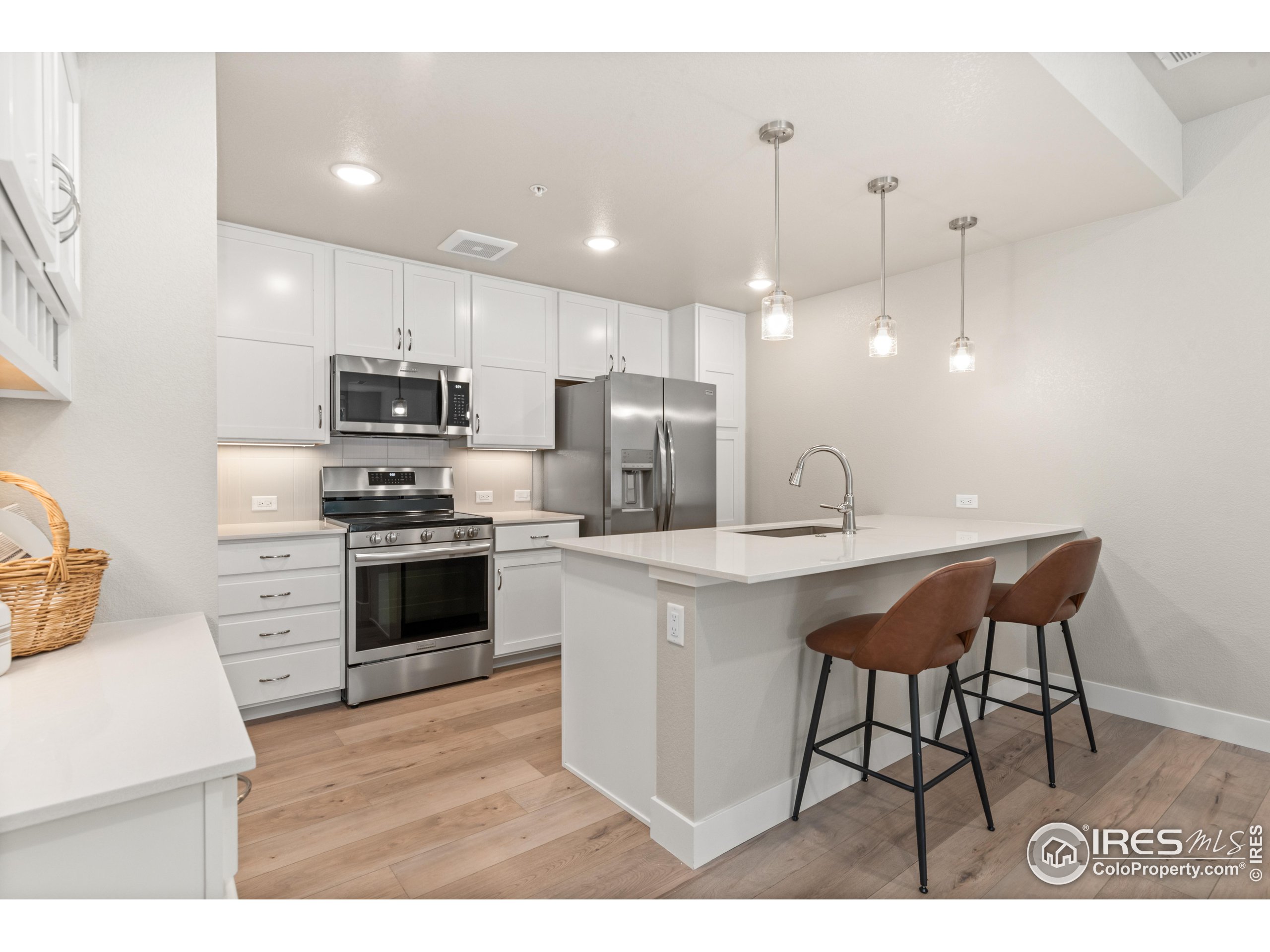 a kitchen with kitchen island a sink stainless steel appliances and cabinets