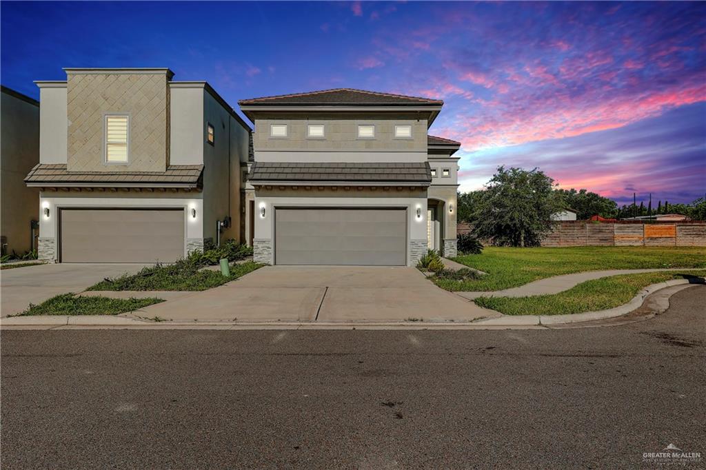 View of front facade featuring a garage