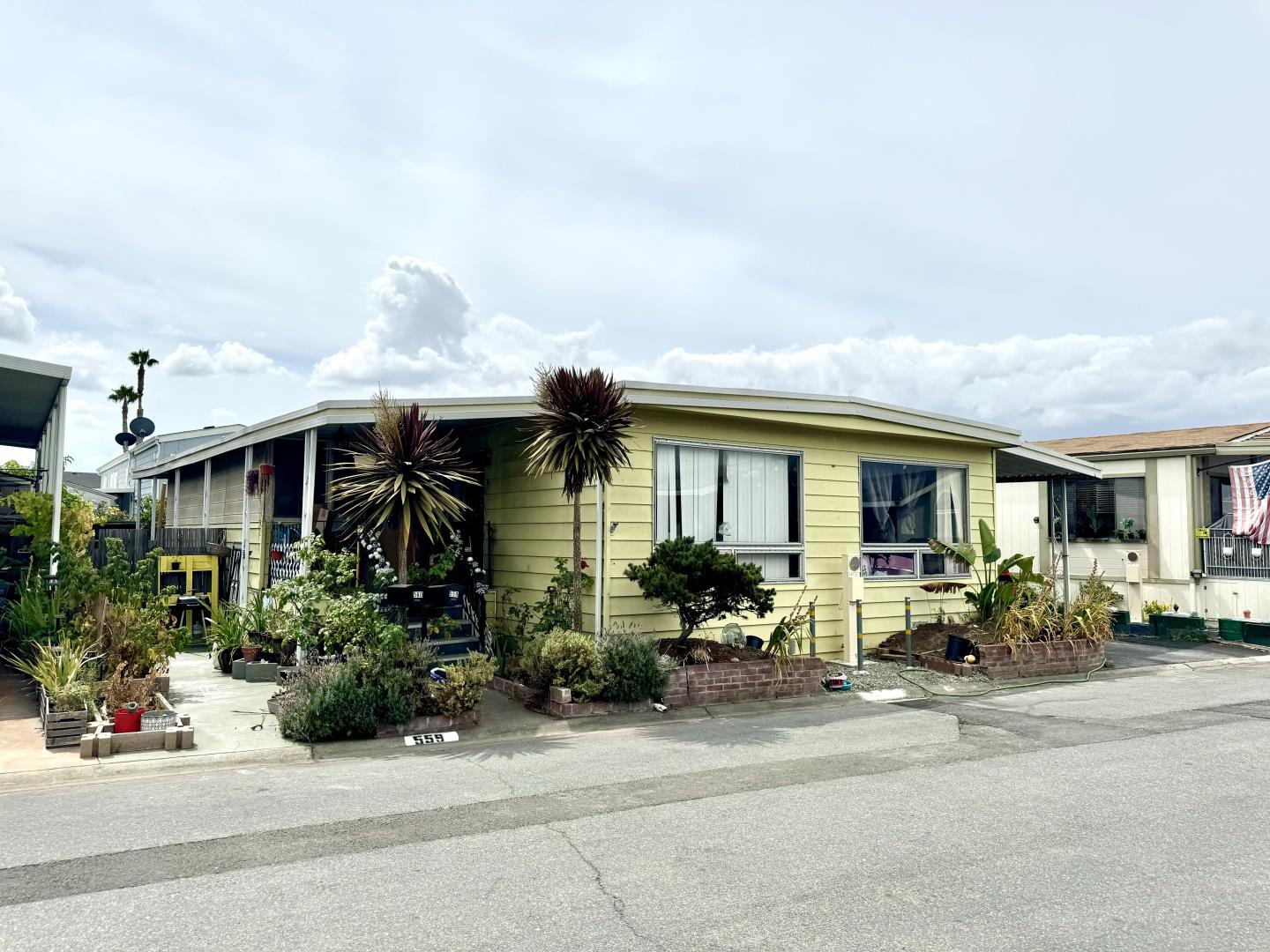 a view of house with car parked in front of it