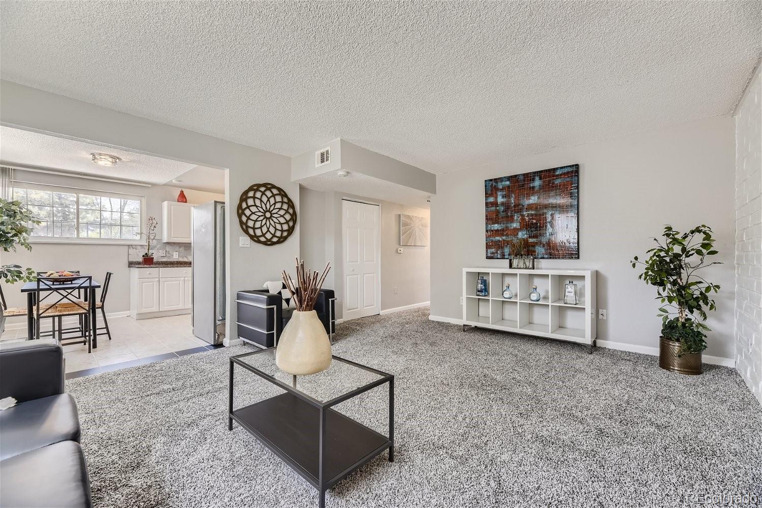 a living room with furniture and a clock