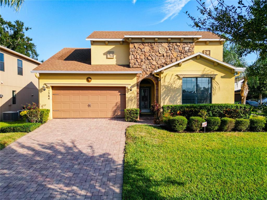 a front view of a house with a yard and garage