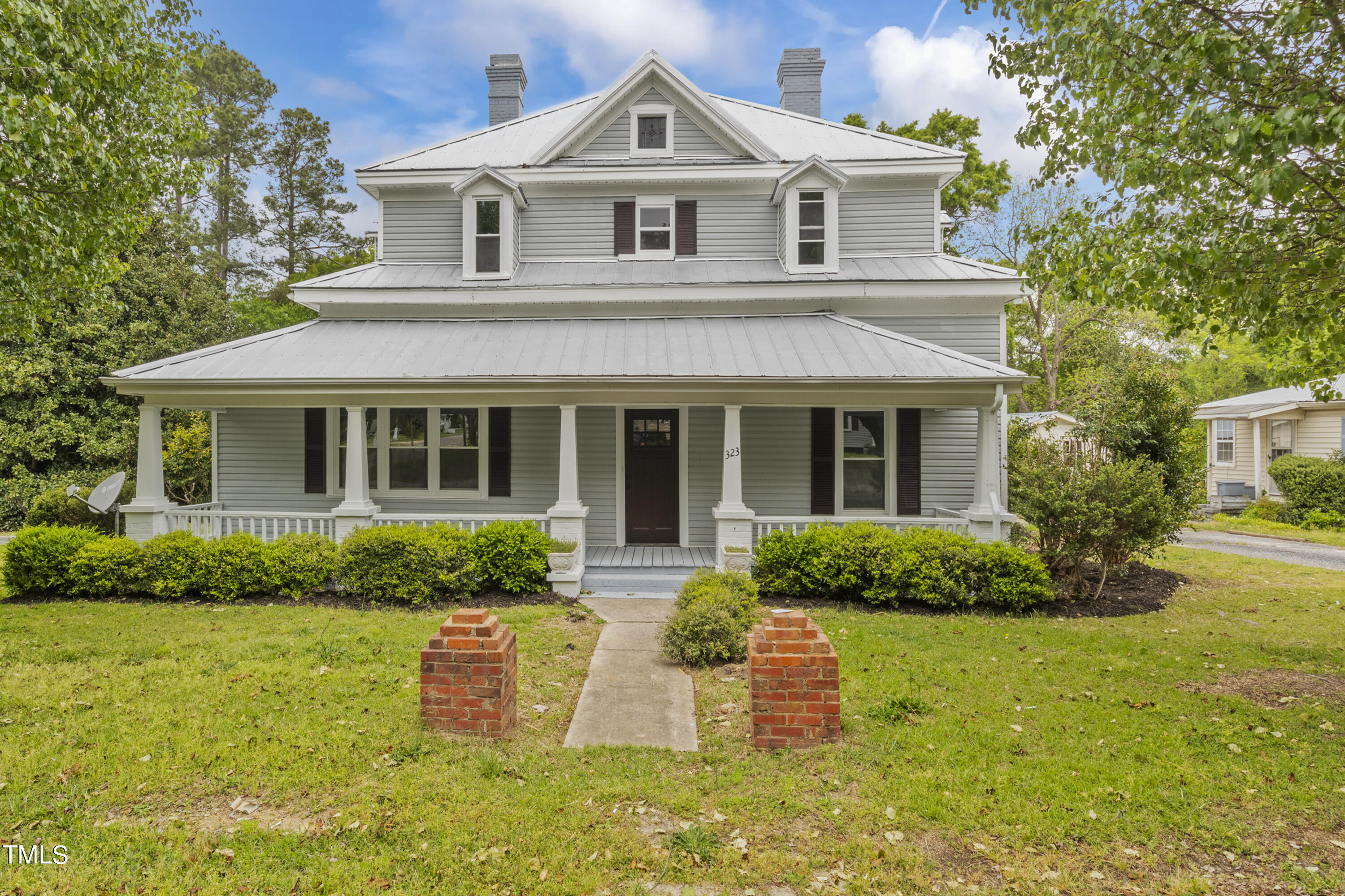 a front view of a house with garden and porch