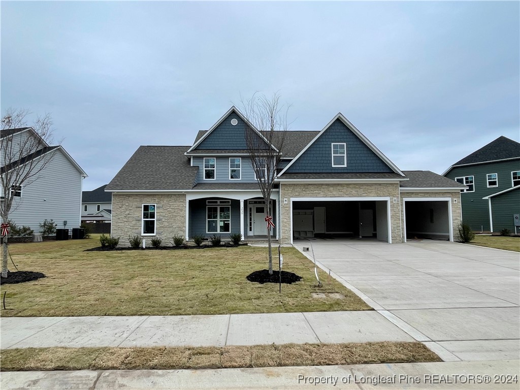 a front view of a house with yard and garage