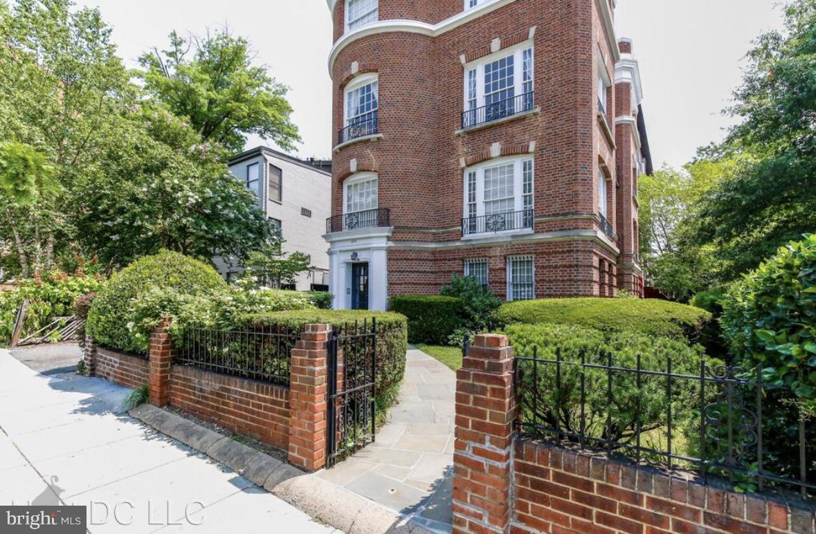 a view of a brick building with many windows