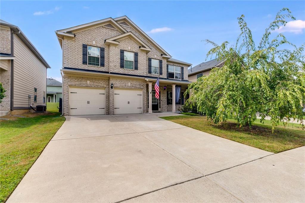 a front view of a house with a yard and garage