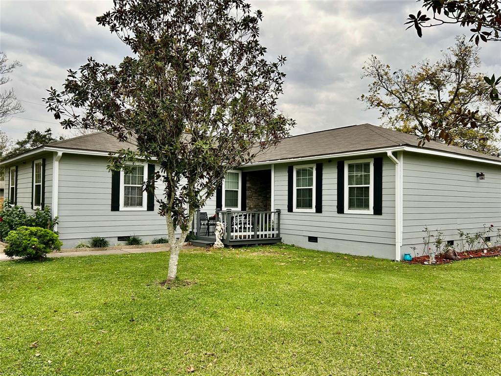 a view of a house with a yard porch and sitting area