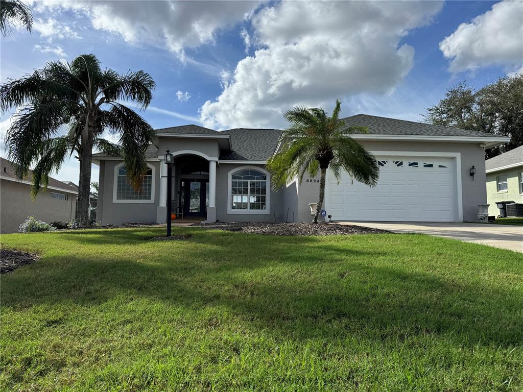 a front view of house with yard and green space