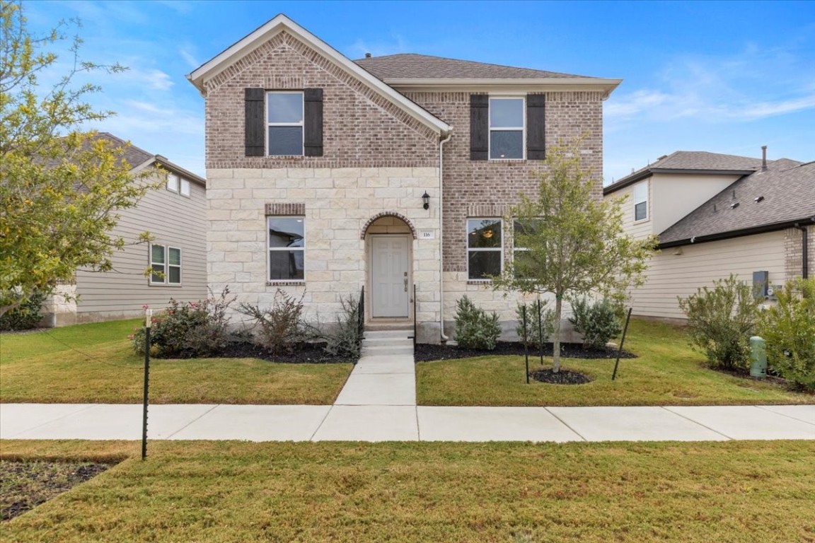 a front view of a house with a yard