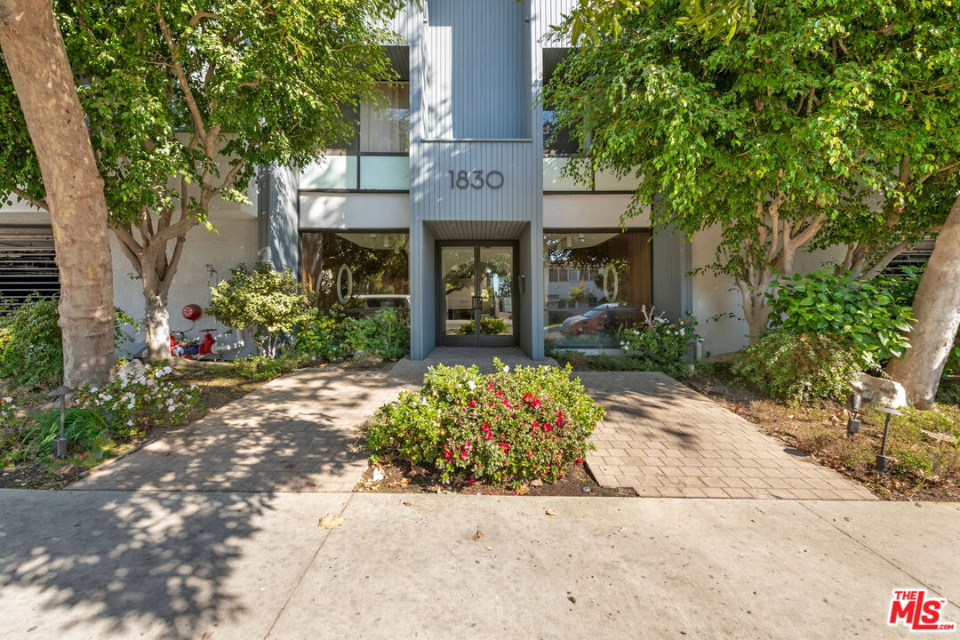 front view of a building with a garden