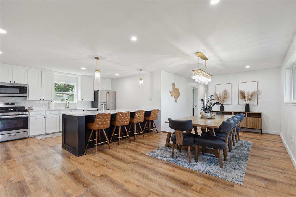 a large kitchen with a table and chairs