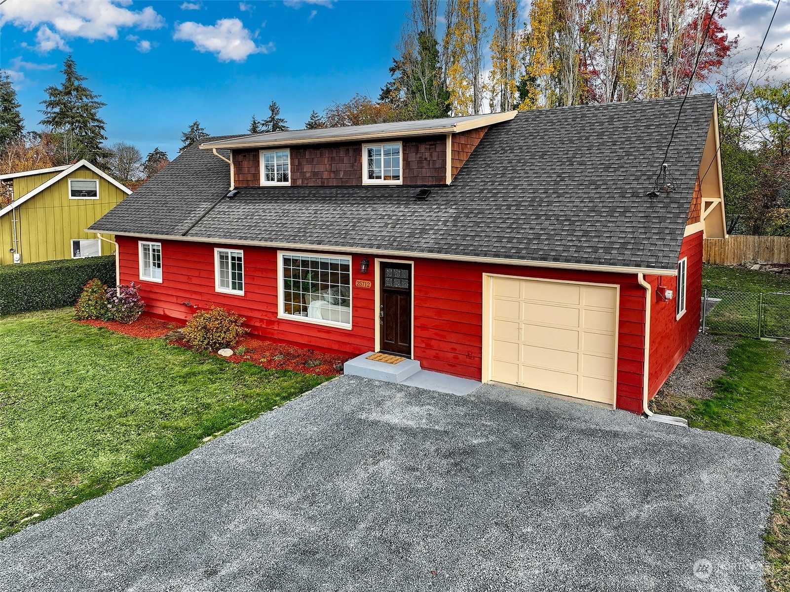 a front view of a house with a yard and garage