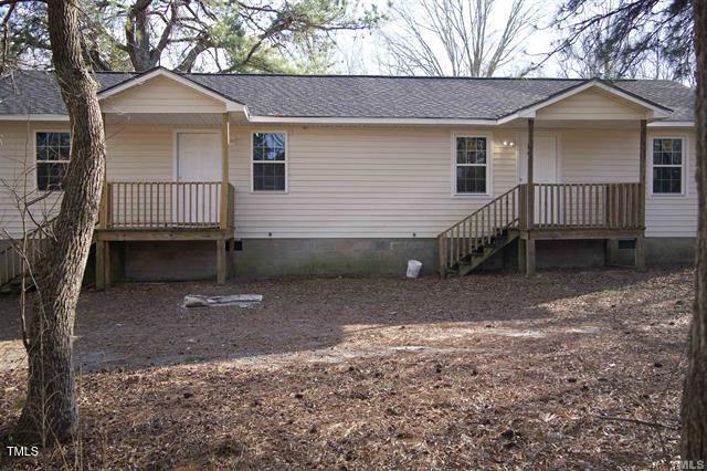 a view of a house with a yard and garage