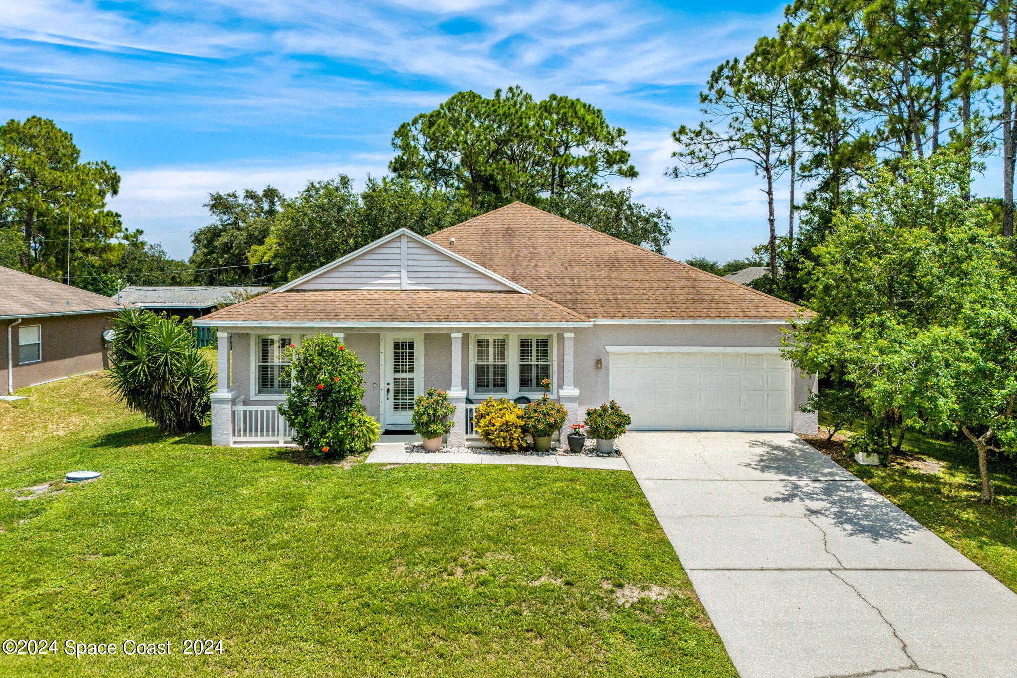 a front view of a house with garden