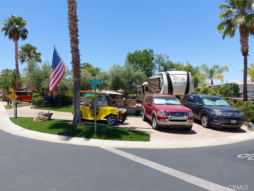 a view of a street with cars parked