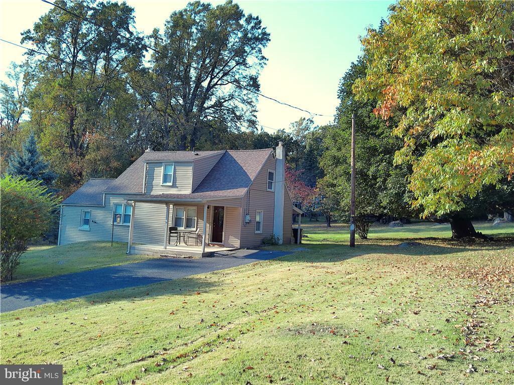 a front view of a house with a yard table and chairs