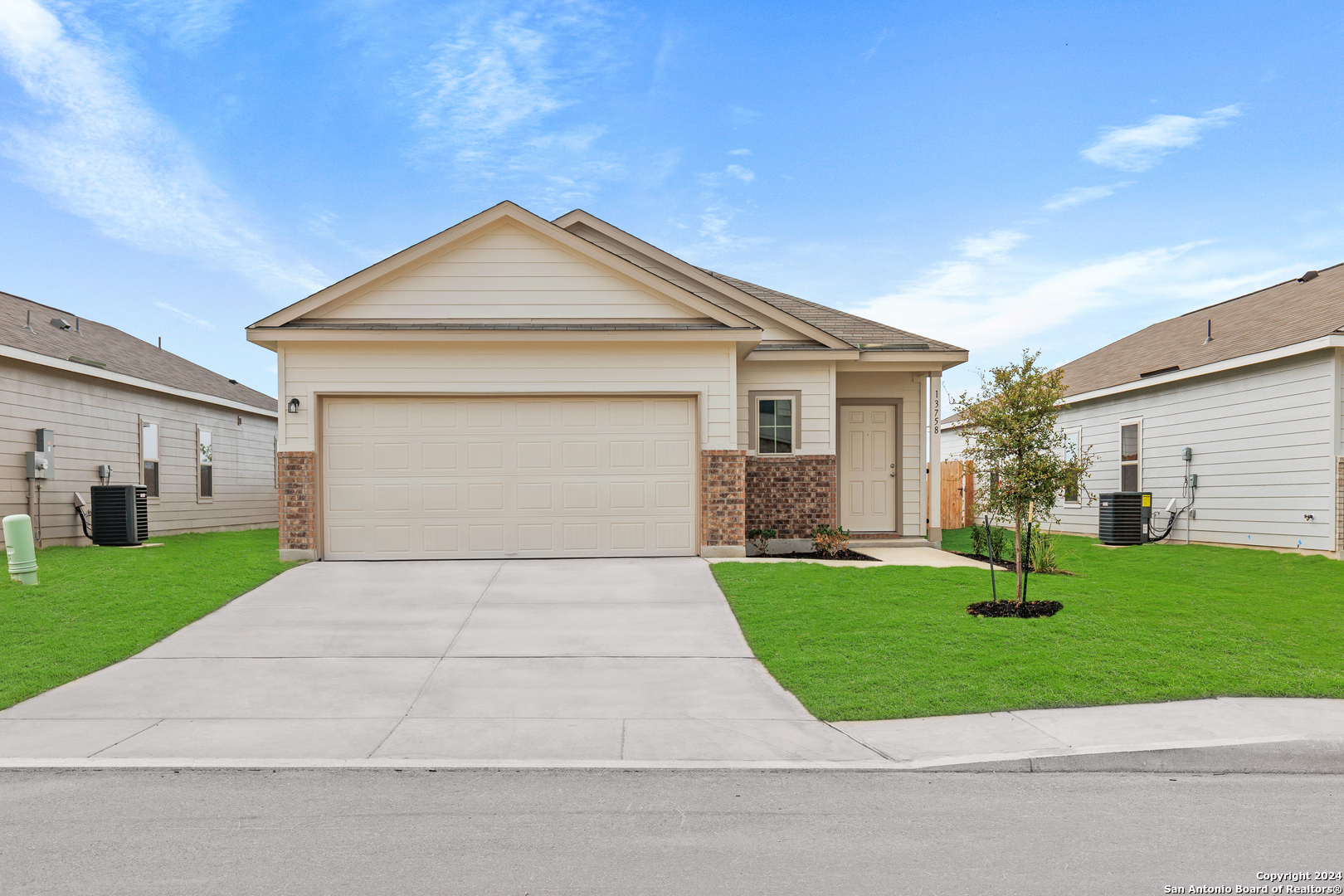 a front view of a house with garden