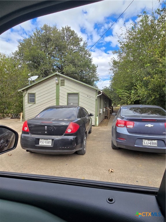 a view of a car parked in front of a house