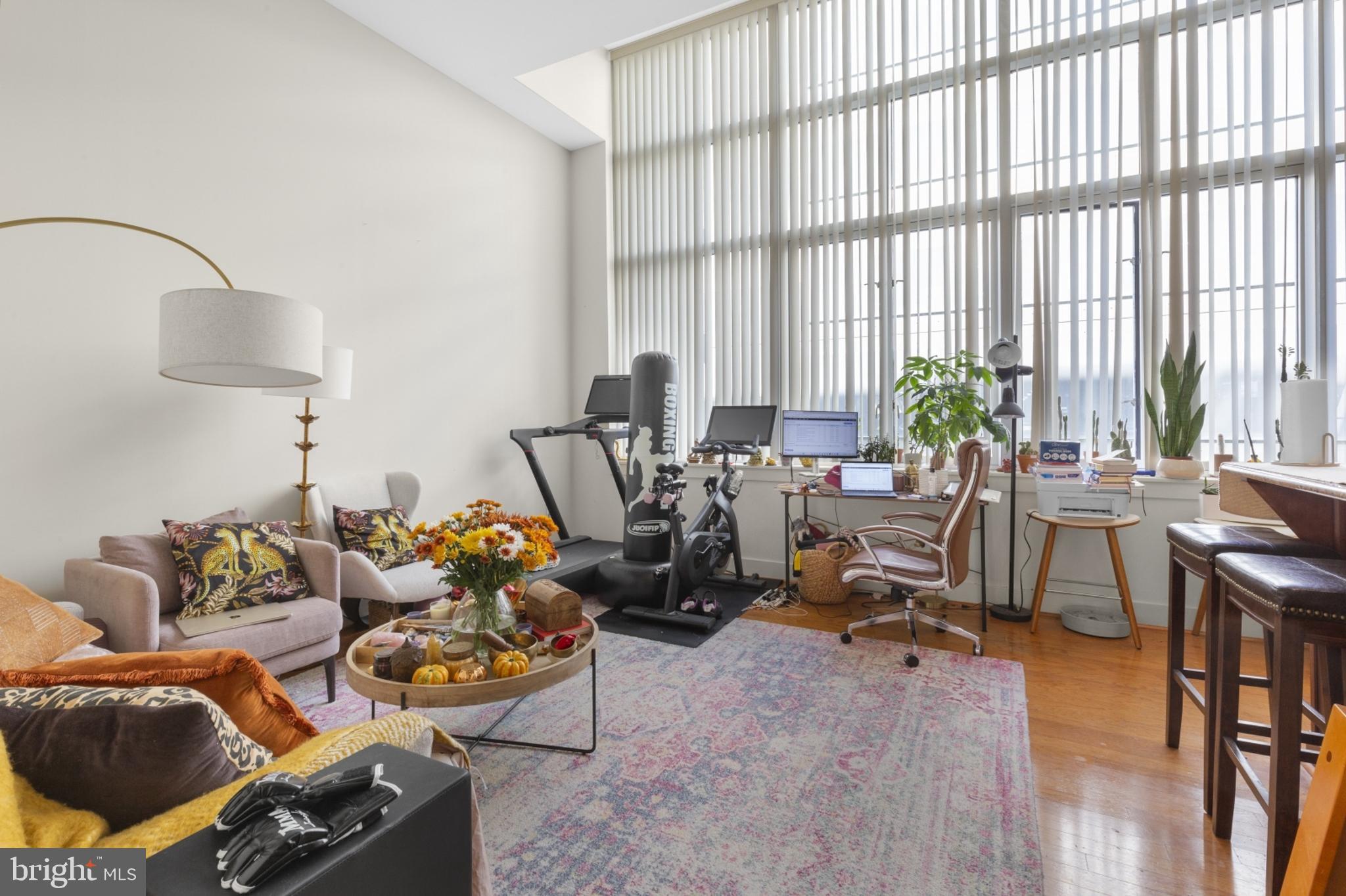 a living room with furniture and floor to ceiling windows