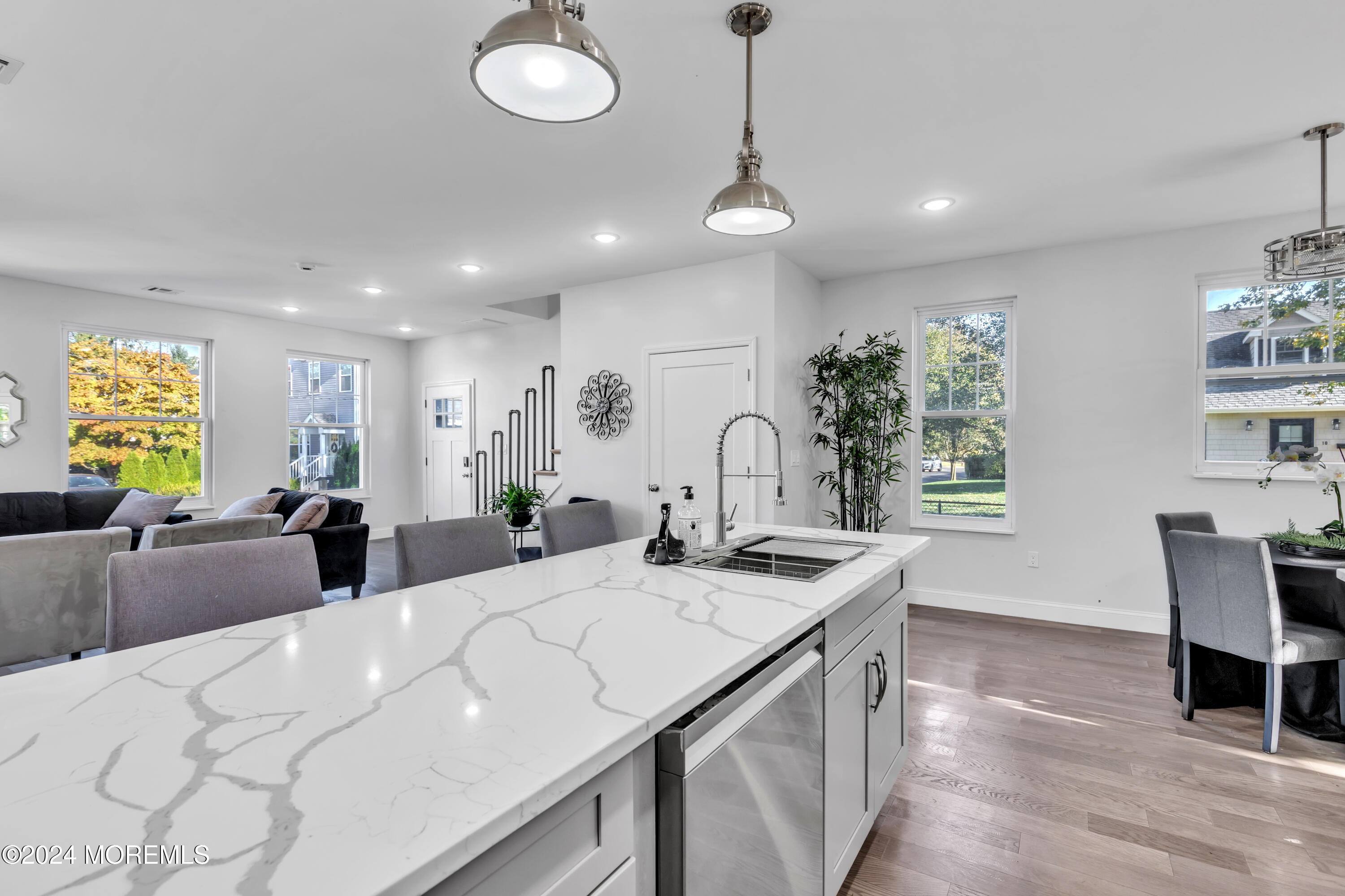 a large white kitchen with a large island